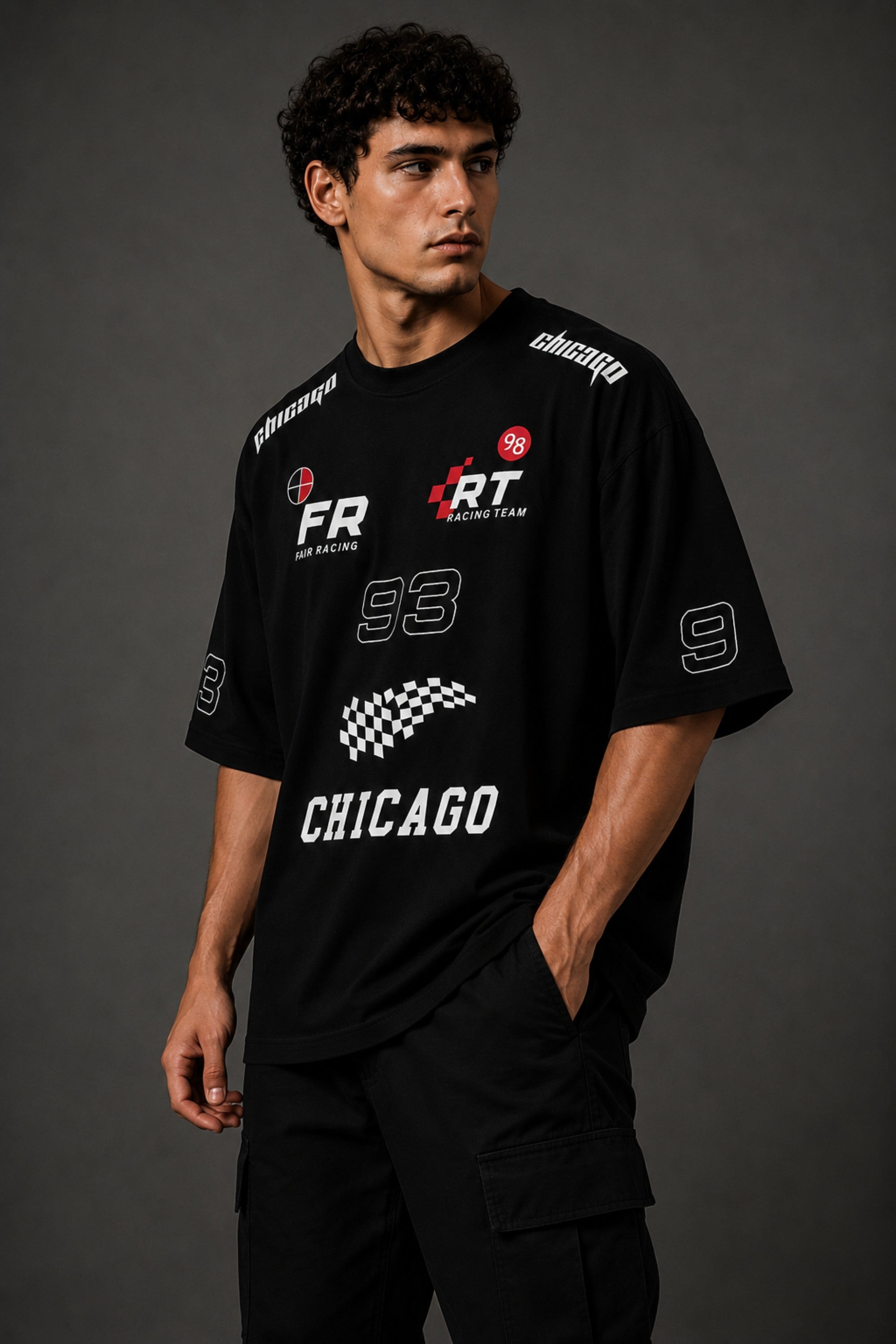 Black oversized t-shirt with 'Chicago' graphic print and racing-inspired logos. Offers premium streetwear style.