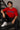 Male model wearing a red oversized t-shirt with 'Believe' printed in navy blue and white collegiate-style lettering.