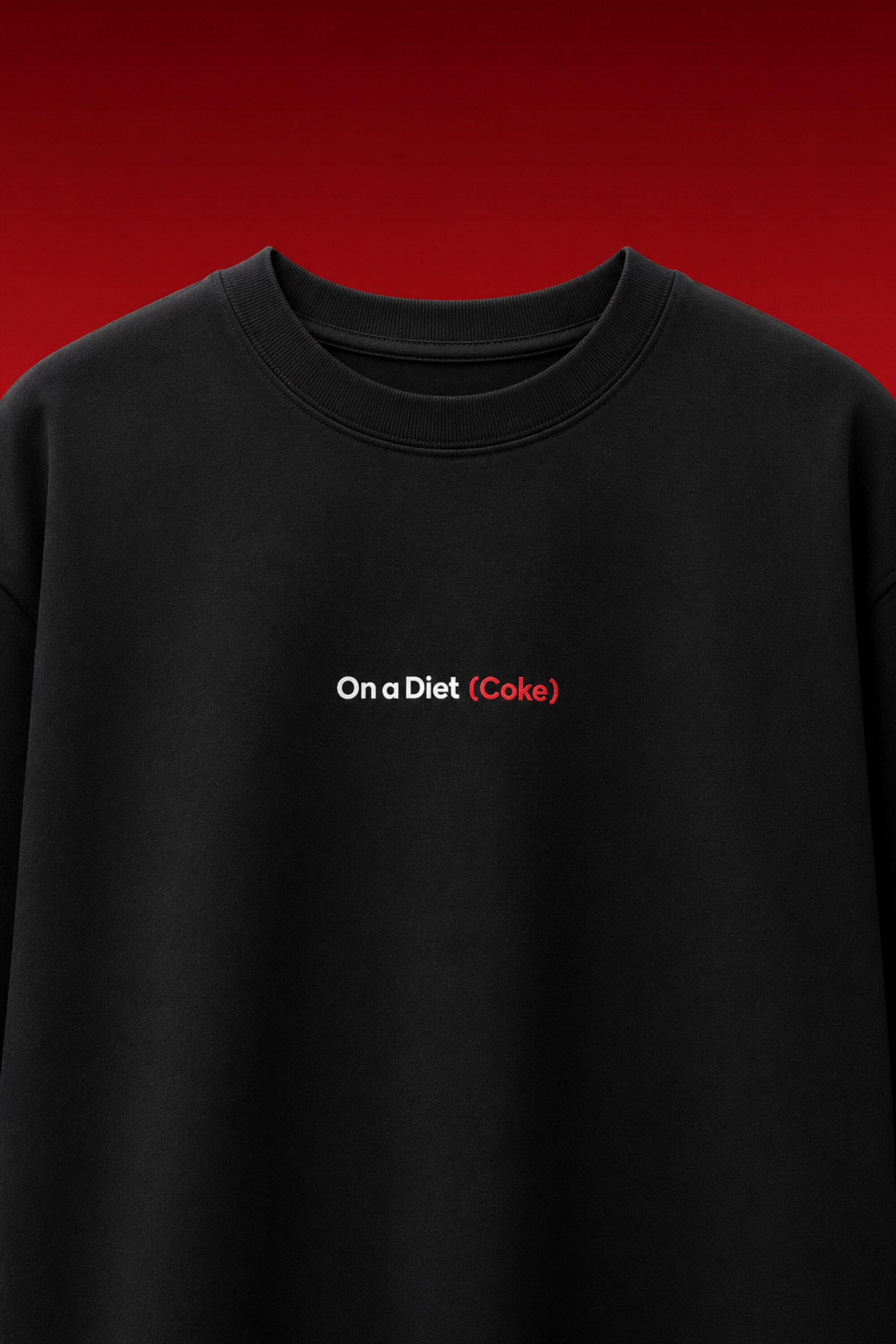 On a Diet Coke black oversized t-shirt with white and red chest print