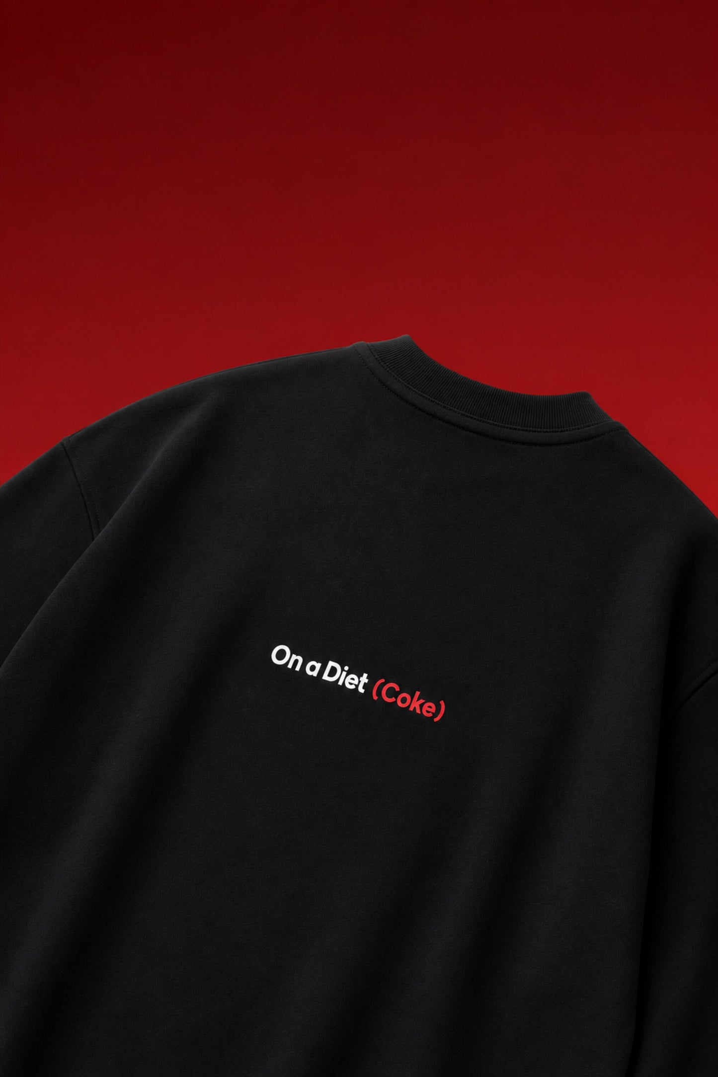 On a Diet Coke black oversized t-shirt with white and red chest print
