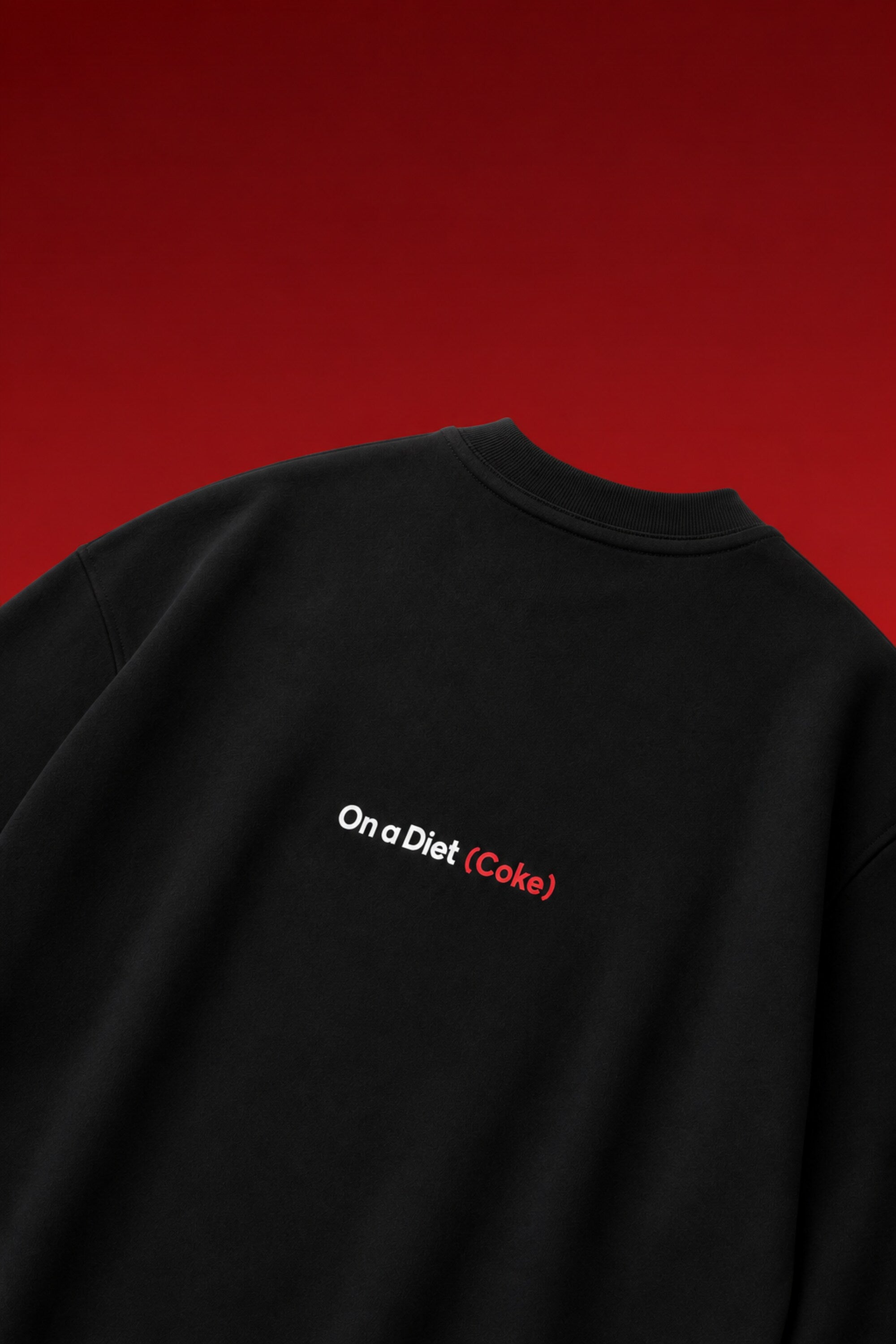 On a Diet Coke black oversized t-shirt with white and red chest print