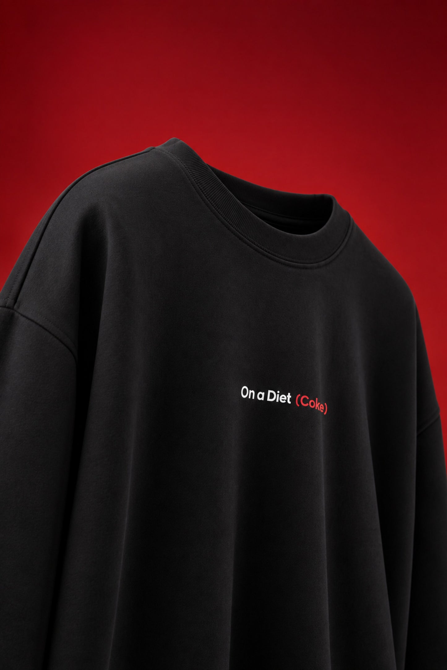 On a Diet Coke black oversized t-shirt with white and red chest print