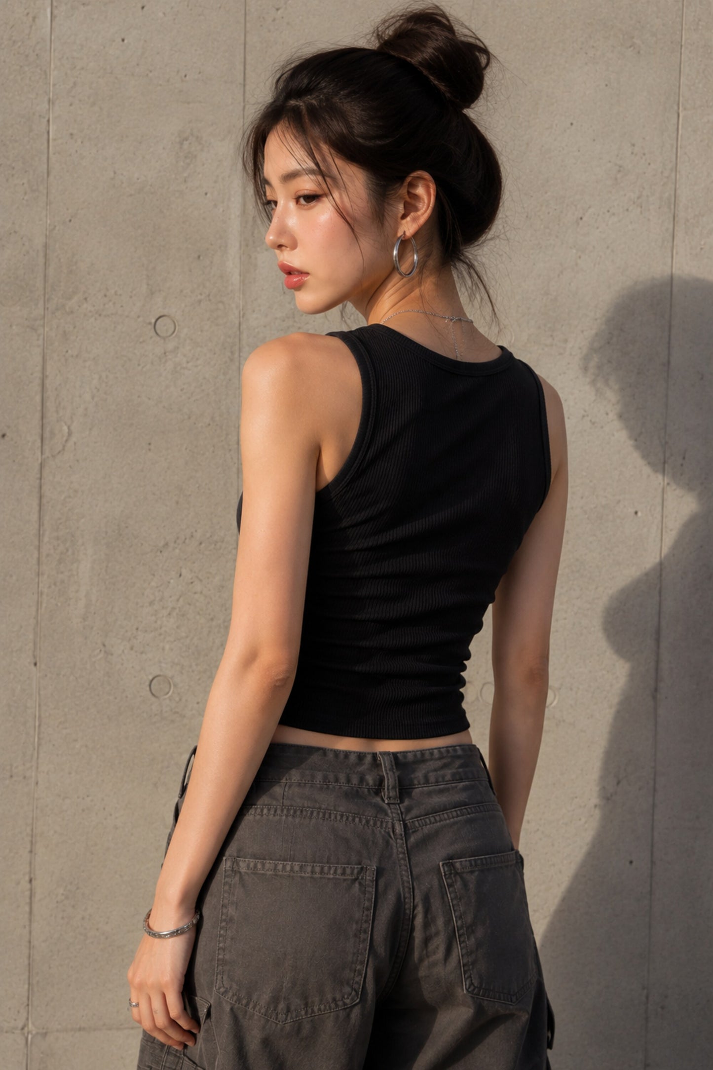 Black ribbed crop tank top with red cursive Don't Be Jealous embroidery on model