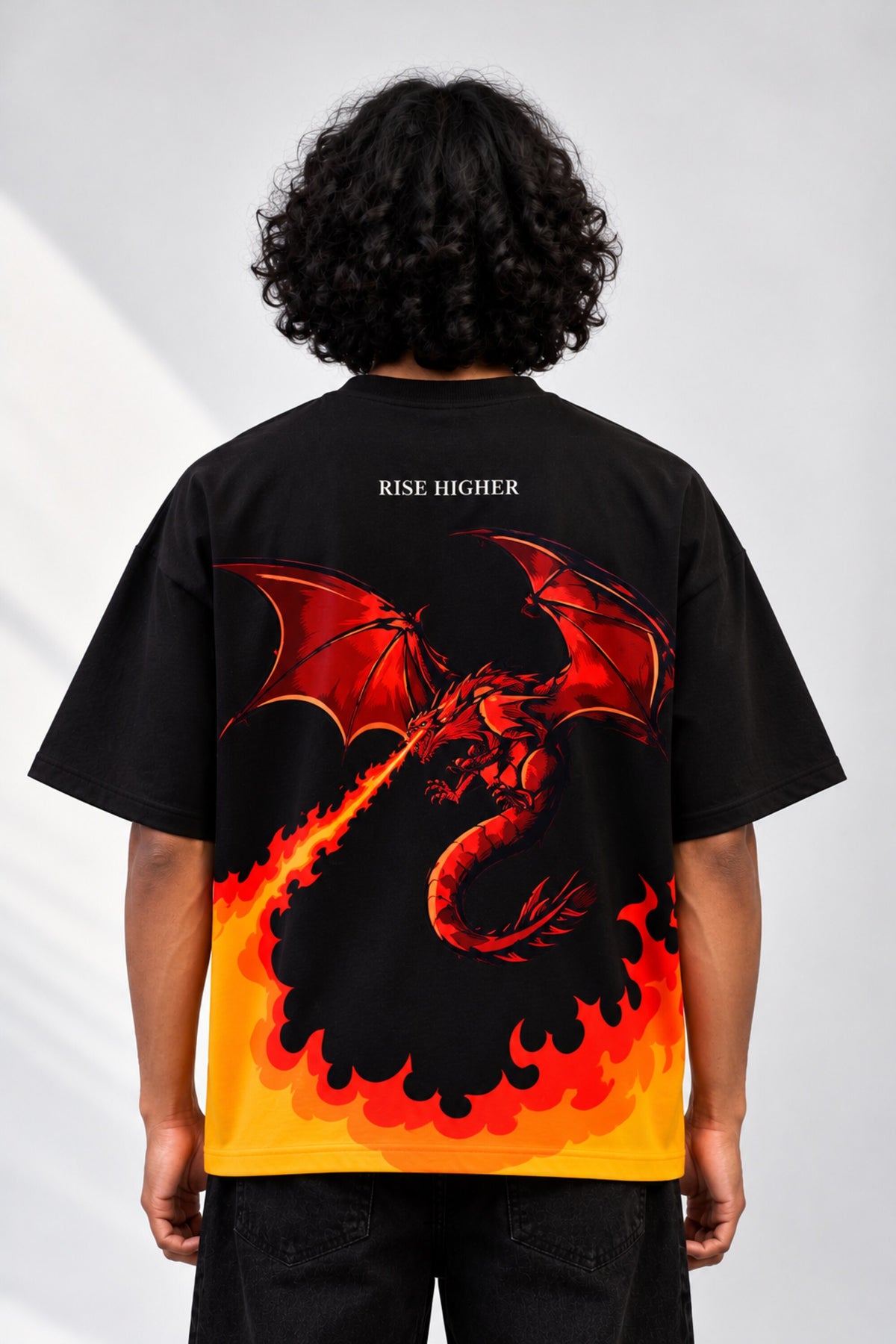 Black oversized tshirt with orange red rising flame wall from hem and Rise Higher text on chest, drop shoulder boxy fit, men India