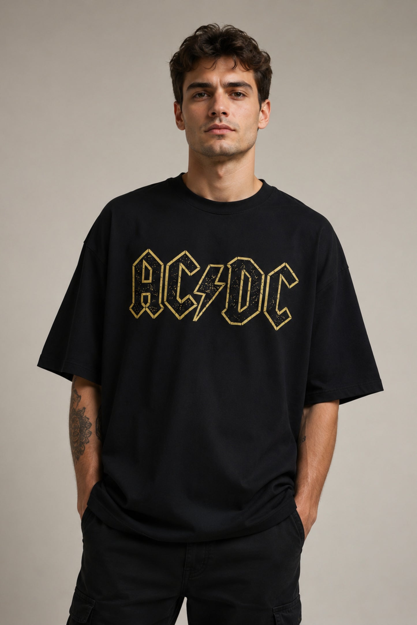 Man wearing a black AC/DC t-shirt against a plain background