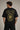Person wearing a black t-shirt with AC/DC graphic design on the back against a gray background