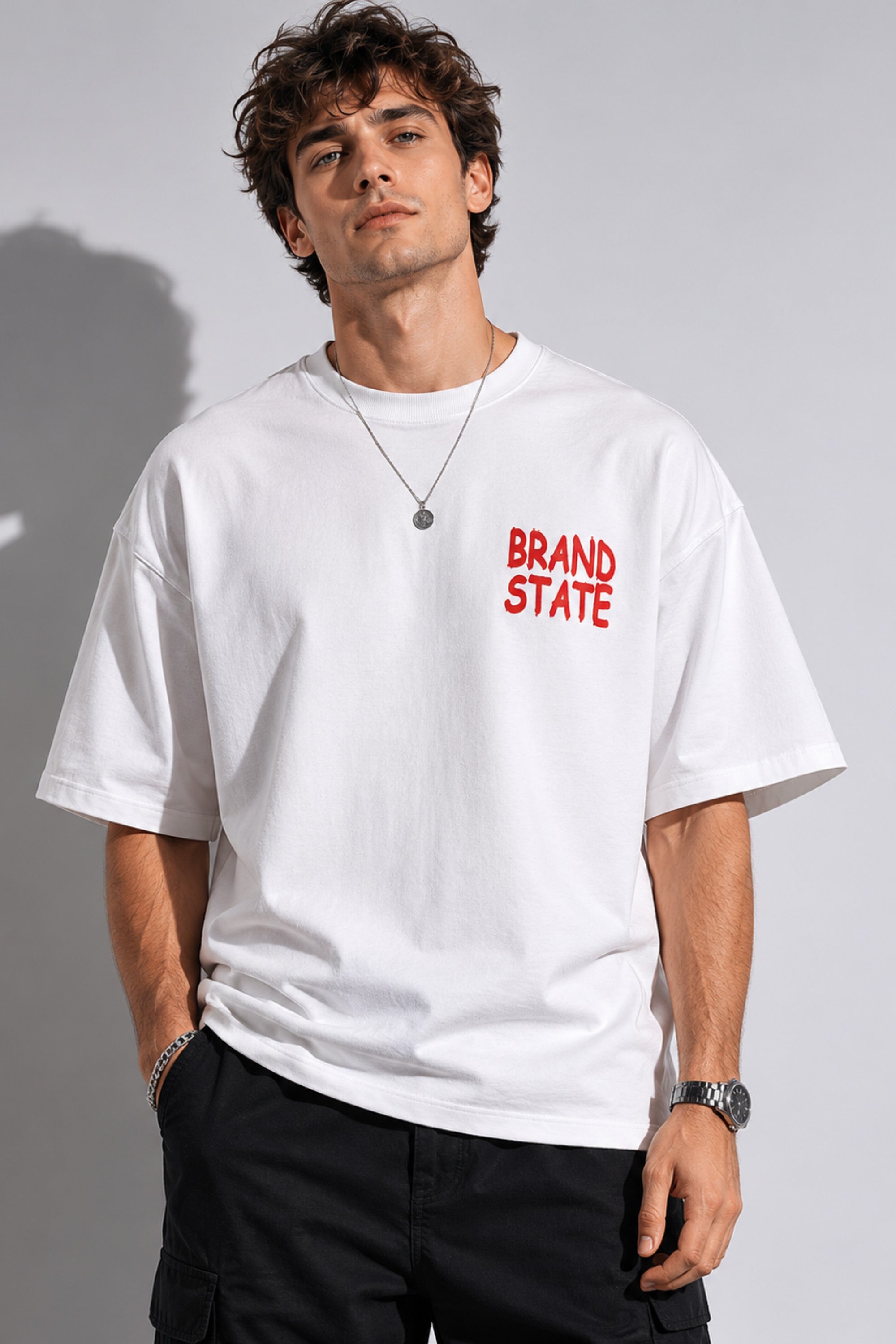 Man wearing a white t-shirt with 'BRAND STATE' in red text on a plain background