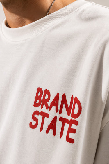 White oversized streetwear t-shirt for men with minimalist red typography chest print and relaxed premium cotton fit