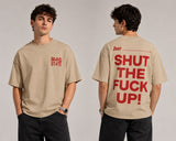 Person wearing a beige t-shirt with red text on front and back, standing against a plain background.