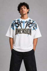 Model wearing a white DIMENSION oversized t-shirt with a black and blue graphic print and a silver chain necklace. - white