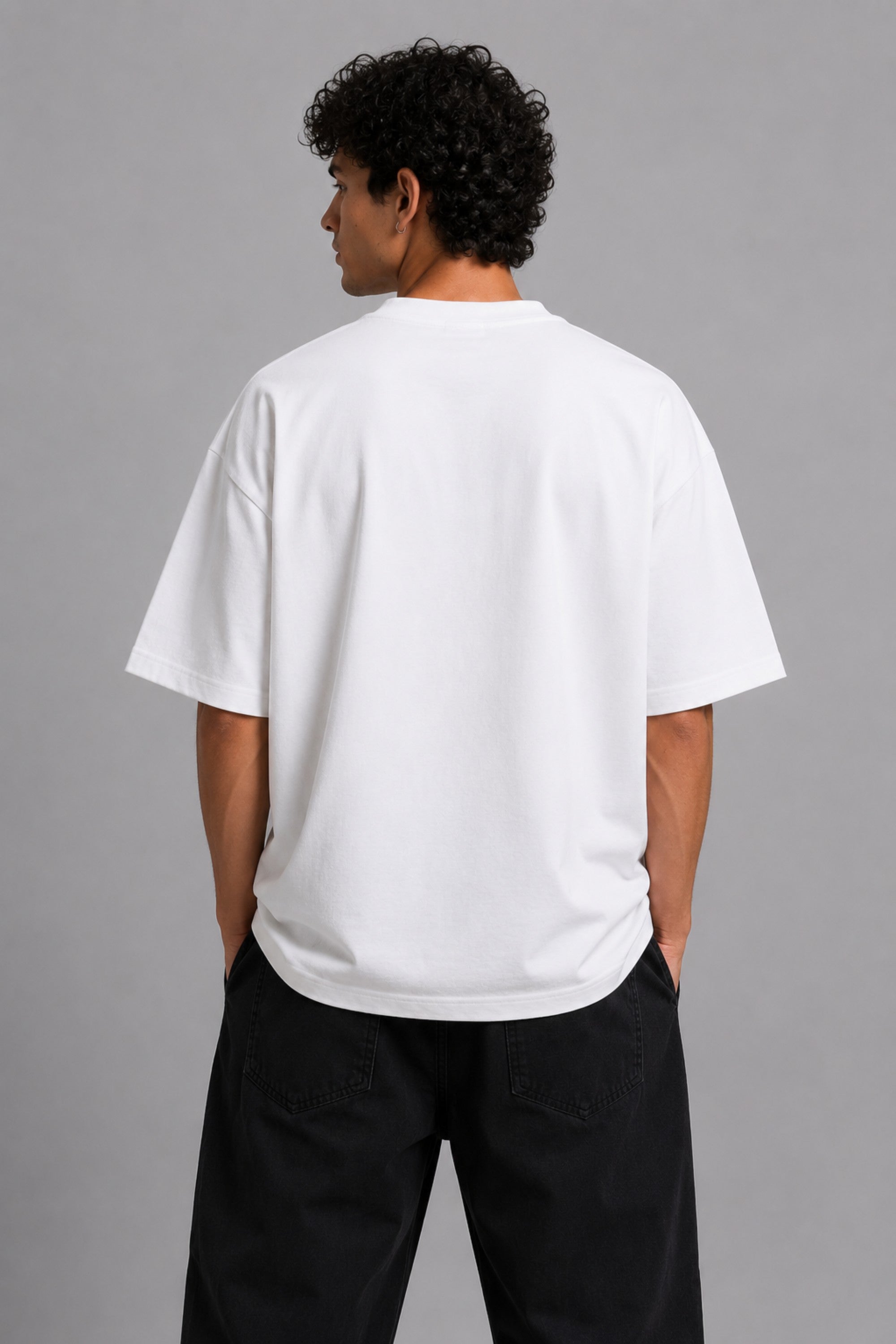 Model wearing a white DIMENSION oversized t-shirt with a black and blue graphic print and a silver chain necklace.