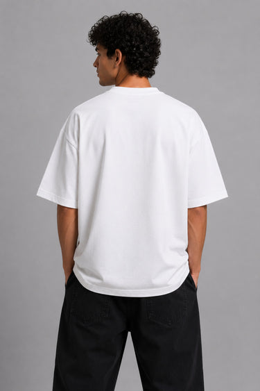 Model wearing a white DIMENSION oversized t-shirt with a black and blue graphic print and a silver chain necklace.