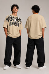 Model wearing a white DIMENSION oversized t-shirt with a black and blue graphic print and a silver chain necklace. - beige