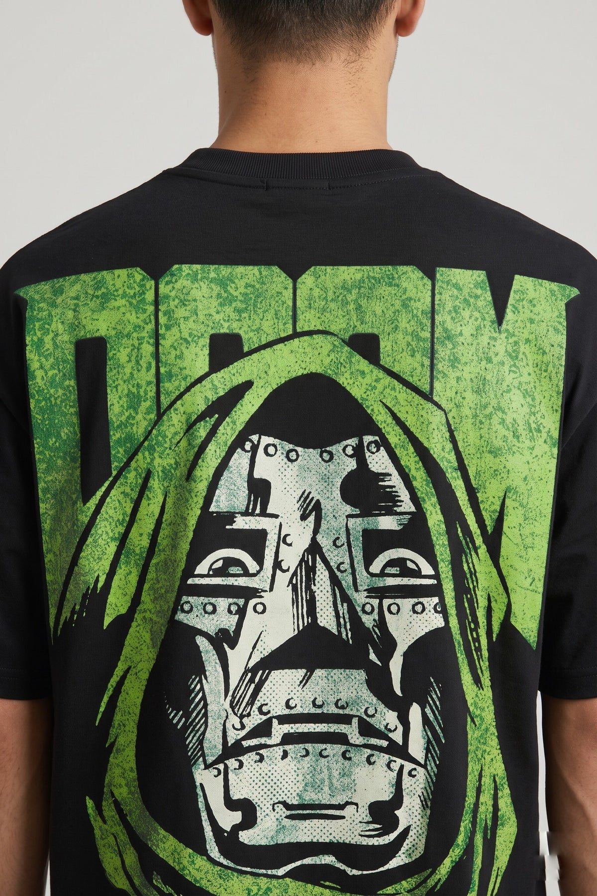 Black oversized tshirt with bold green DOOM text and Dr Doom metallic mask face on back, drop shoulder boxy fit, men India - doom design shot 1