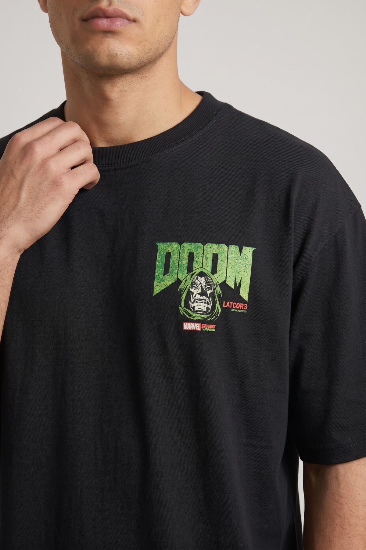 Black oversized tshirt with bold green DOOM text and Dr Doom metallic mask face on back, drop shoulder boxy fit, men India - doom design shot 2