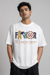 Man wearing a white oversized FAKR t-shirt with a graphic design of the word "Fakr" integrated with superhero symbols, on a plain gray background.