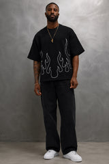 Black oversized t-shirt with large white outline flame design on front, streetwear fashion India