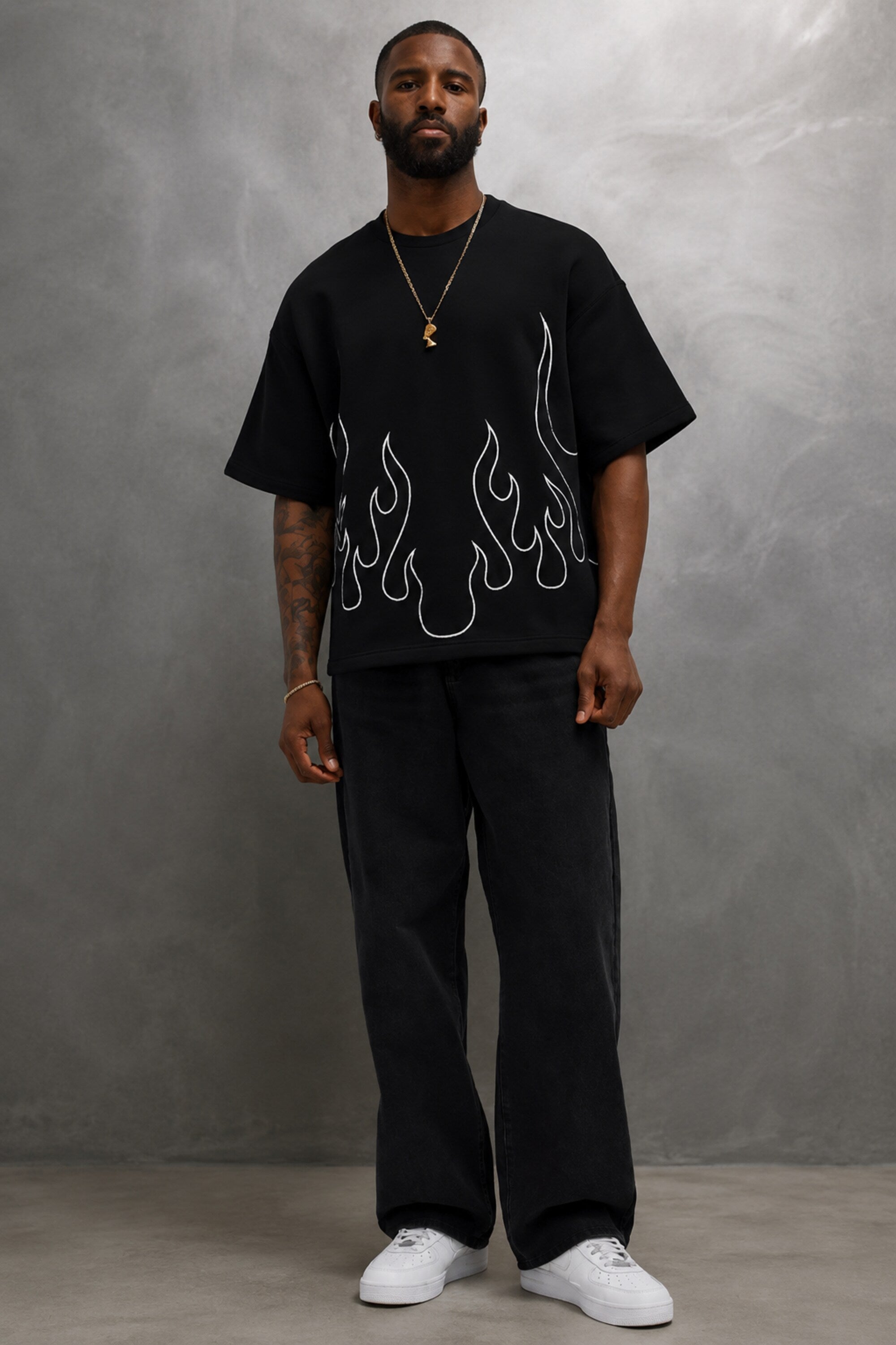 Black oversized t-shirt with large white outline flame design on front, streetwear fashion India