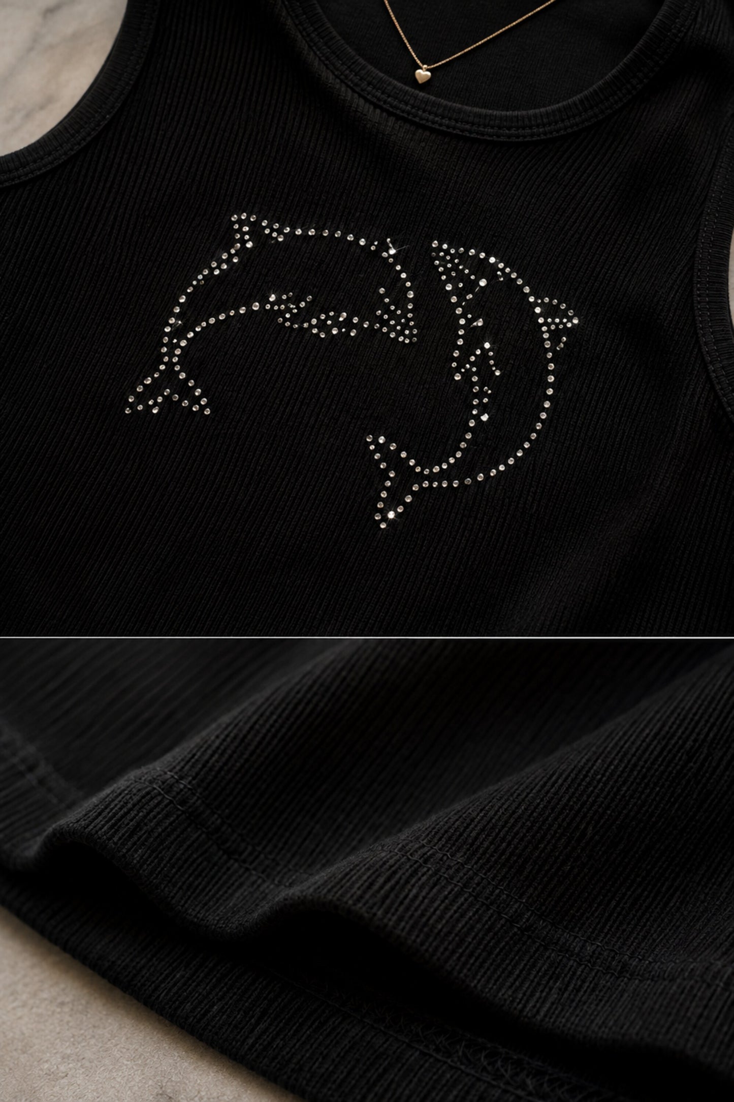 Black ribbed crop tank top with silver rhinestone dolphin graphic on model