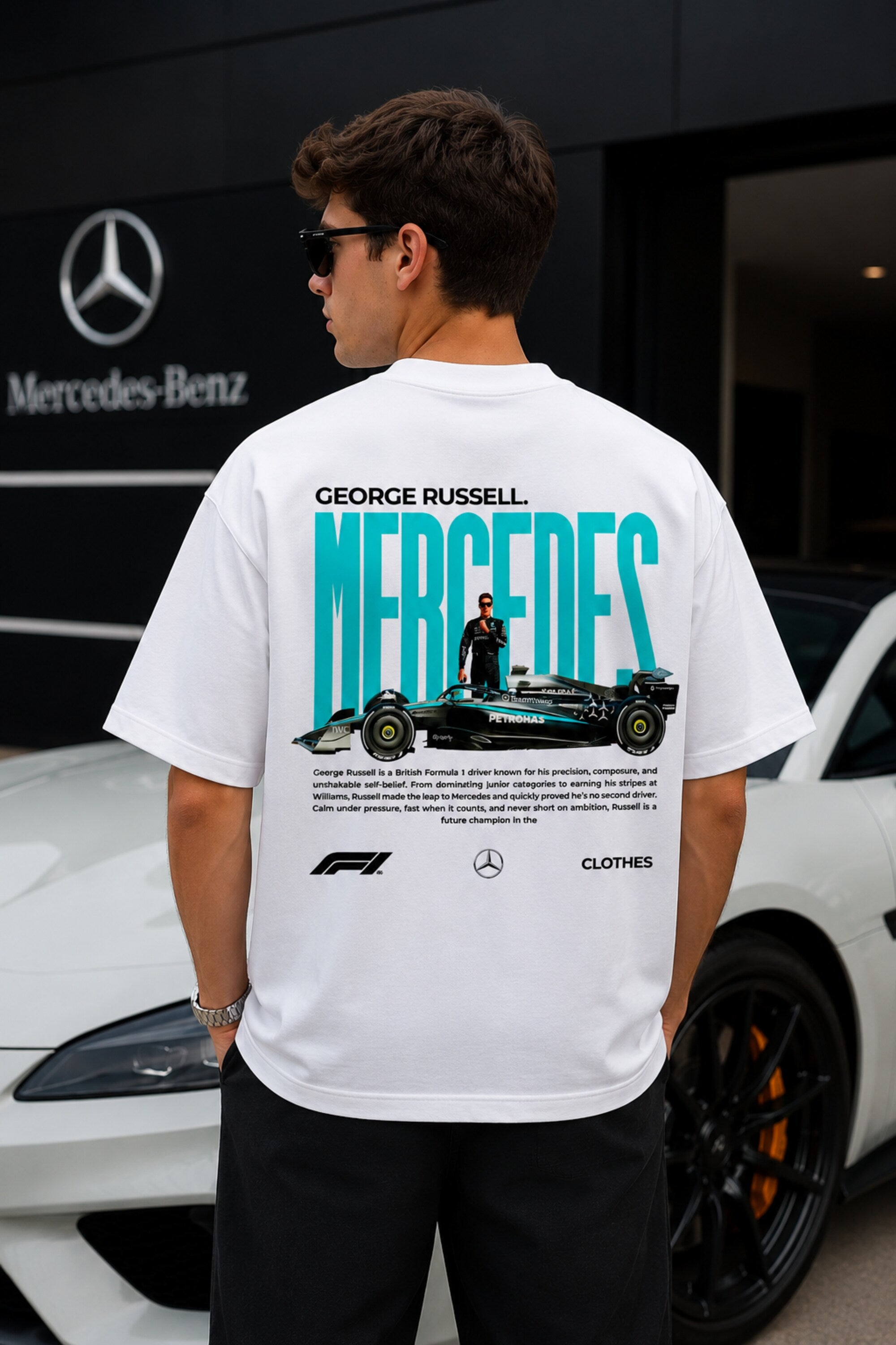 Model wearing white POPCASE George Russell Mercedes oversized t shirt with star logo on chest and teal MERCEDES race car back graphic