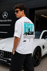 Model wearing white POPCASE George Russell Mercedes oversized t shirt with star logo on chest and teal MERCEDES race car back graphic