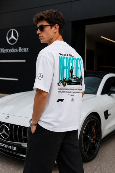 Model wearing white POPCASE George Russell Mercedes oversized t shirt with star logo on chest and teal MERCEDES race car back graphic