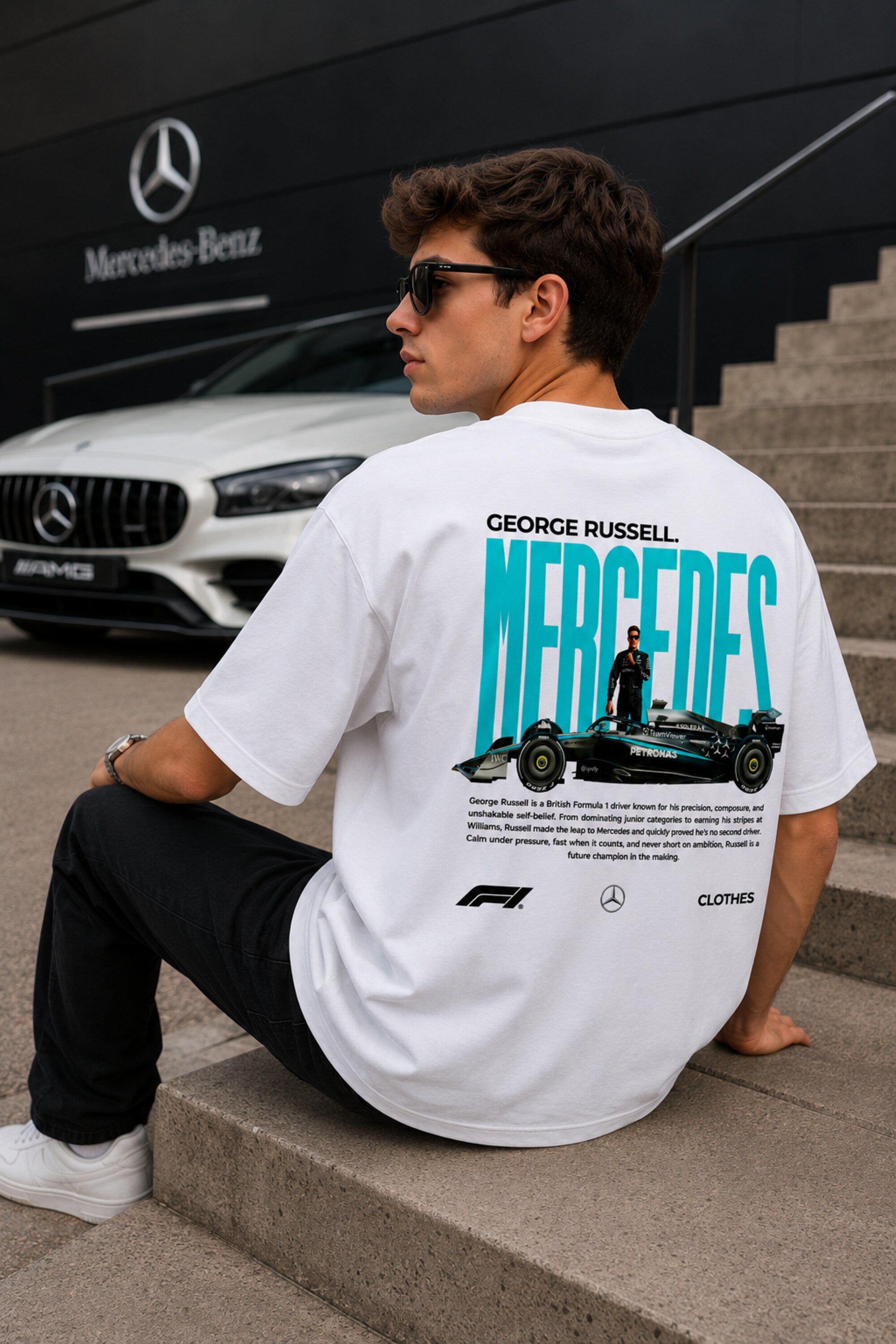 Model wearing white POPCASE George Russell Mercedes oversized t shirt with star logo on chest and teal MERCEDES race car back graphic