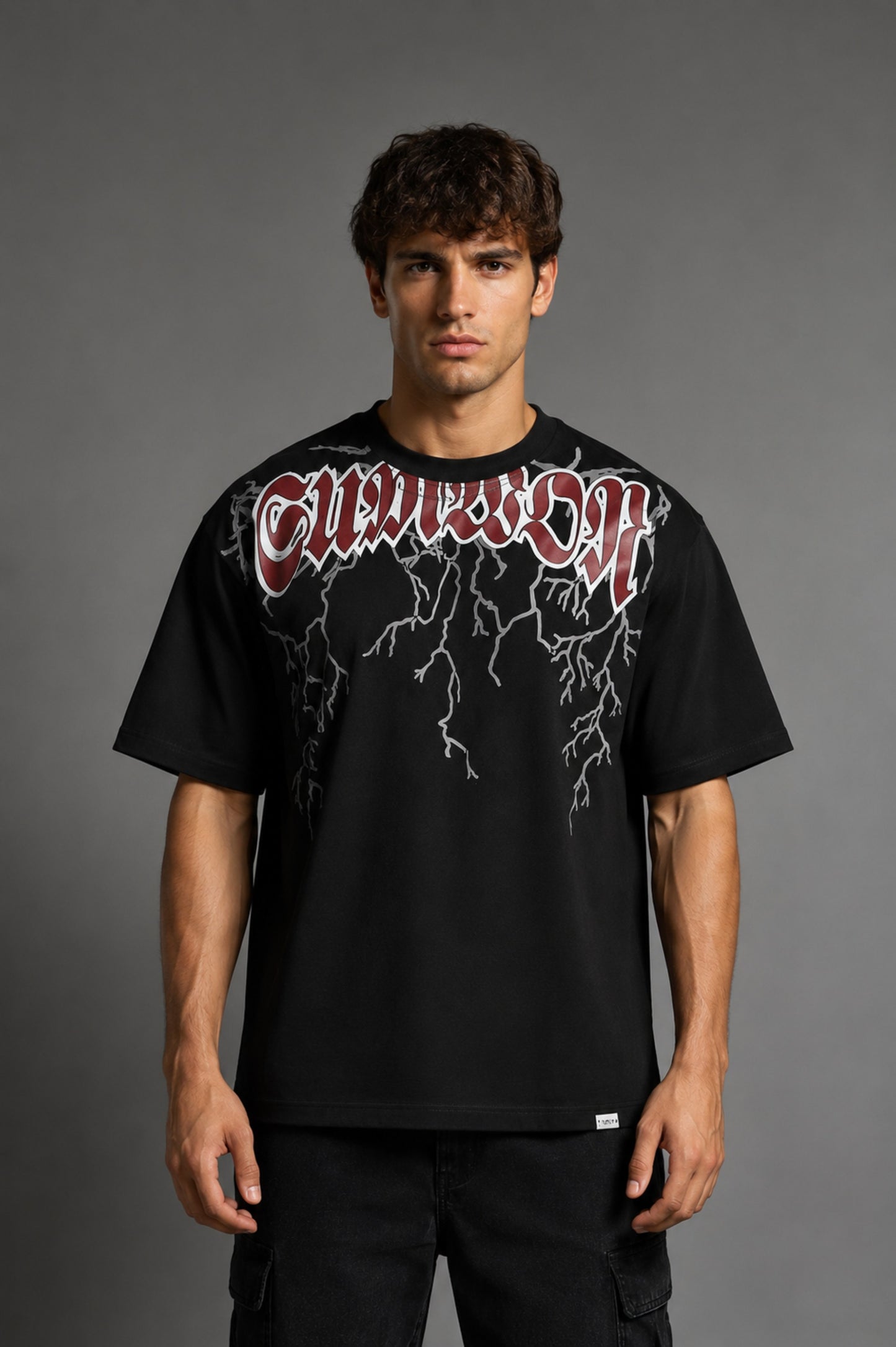 Guardian Design black oversized t-shirt with a bold red and white lightning bolt graphic print. Shot on a model, showcasing the relaxed, streetwear fit.