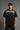 Guardian Design black oversized t-shirt with a bold red and white lightning bolt graphic print. Shot on a model, showcasing the relaxed, streetwear fit.