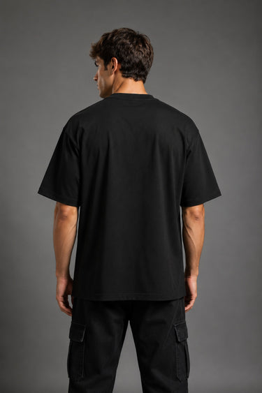 Guardian Design black oversized t-shirt with a bold red and white lightning bolt graphic print. Shot on a model, showcasing the relaxed, streetwear fit.
