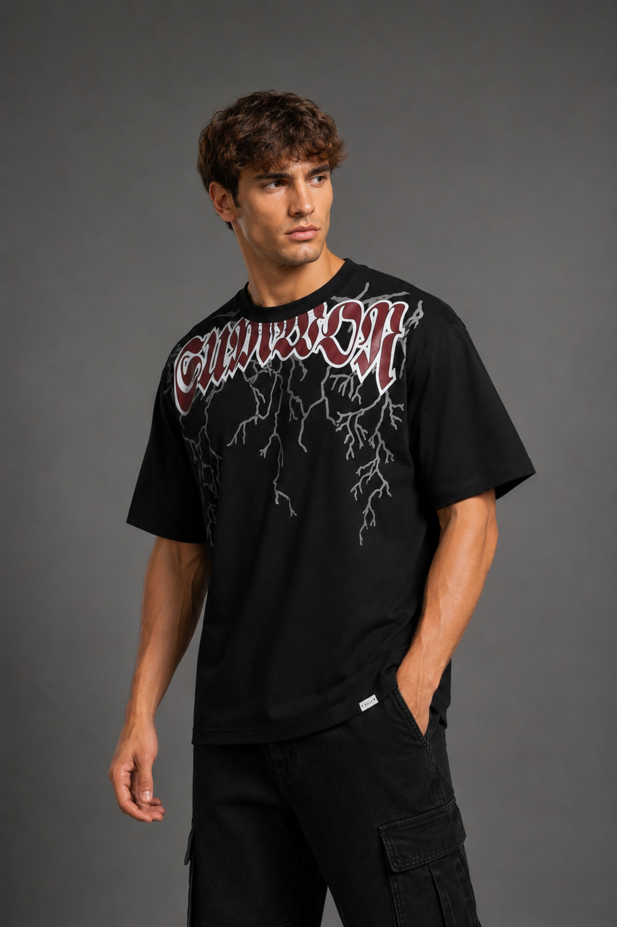 Guardian Design black oversized t-shirt with a bold red and white lightning bolt graphic print. Shot on a model, showcasing the relaxed, streetwear fit.