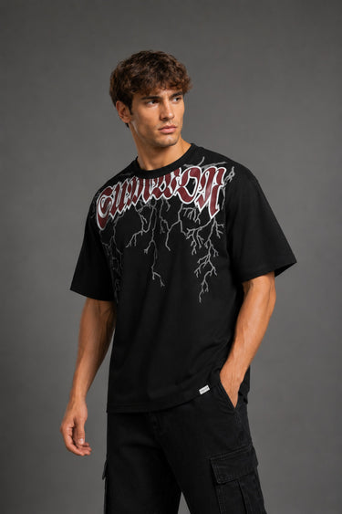 Guardian Design black oversized t-shirt with a bold red and white lightning bolt graphic print. Shot on a model, showcasing the relaxed, streetwear fit.