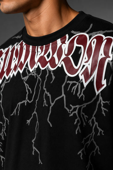 Guardian Design black oversized t-shirt with a bold red and white lightning bolt graphic print. Shot on a model, showcasing the relaxed, streetwear fit.