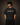 Man wearing an anthracite black 85-DENIM oversized t-shirt featuring a vibrant Hanumanji graphic print and Hindi text 'Mahabali' on the back. Styled for streetwear.