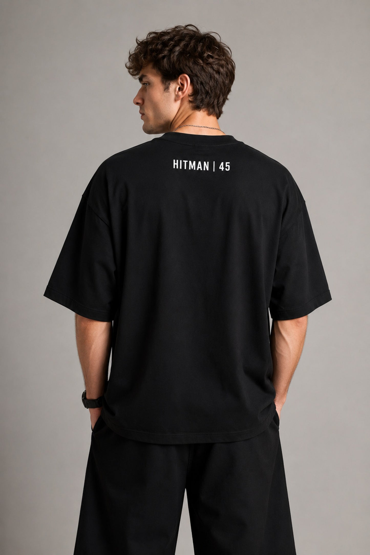 Black oversized t-shirt with cinematic Rohit Sharma Hitman batting photo blue glow Beyond the ARCi bold text 220 GSM DTF print