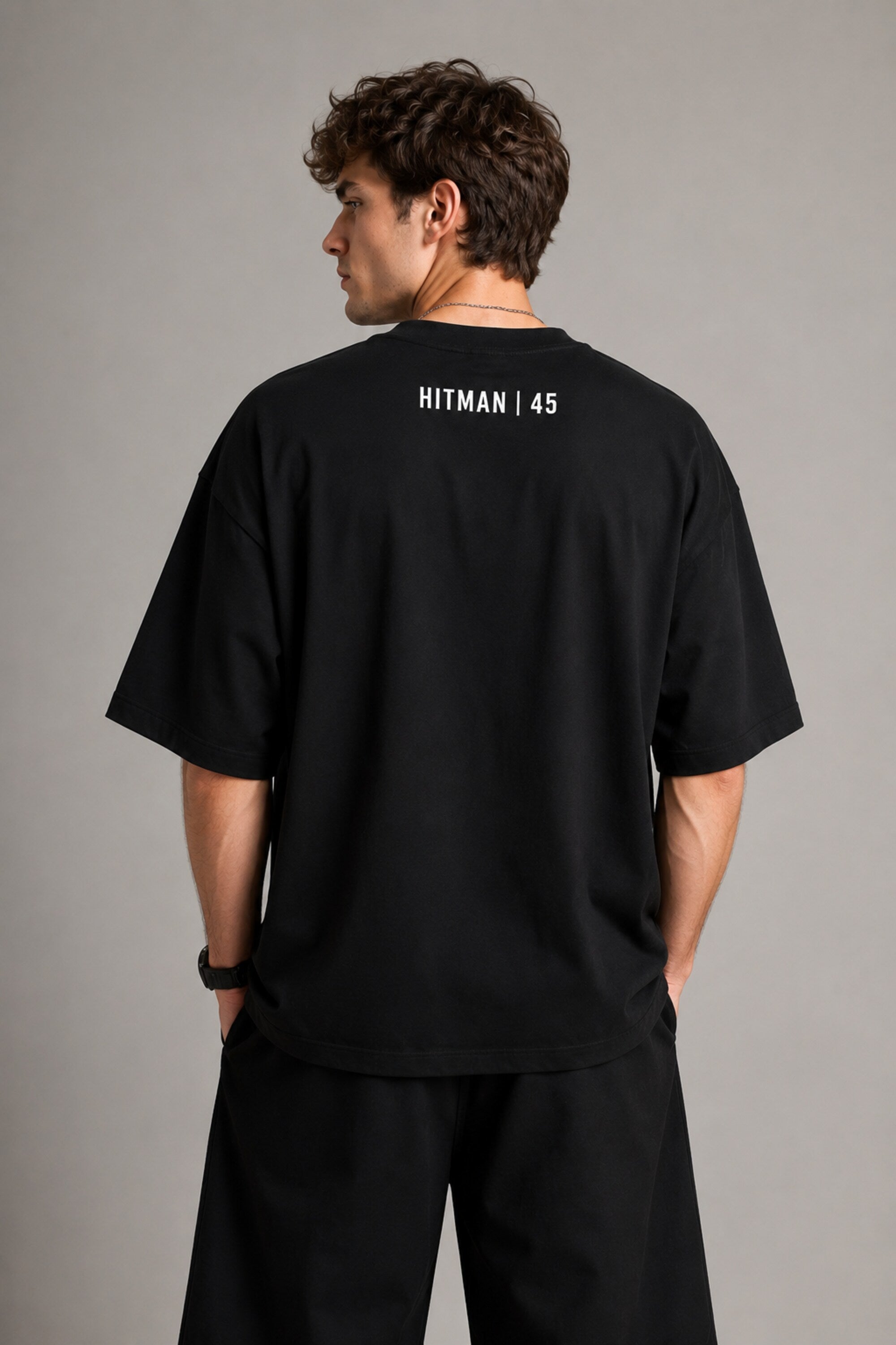 Black oversized t-shirt with cinematic Rohit Sharma Hitman batting photo blue glow Beyond the ARCi bold text 220 GSM DTF print