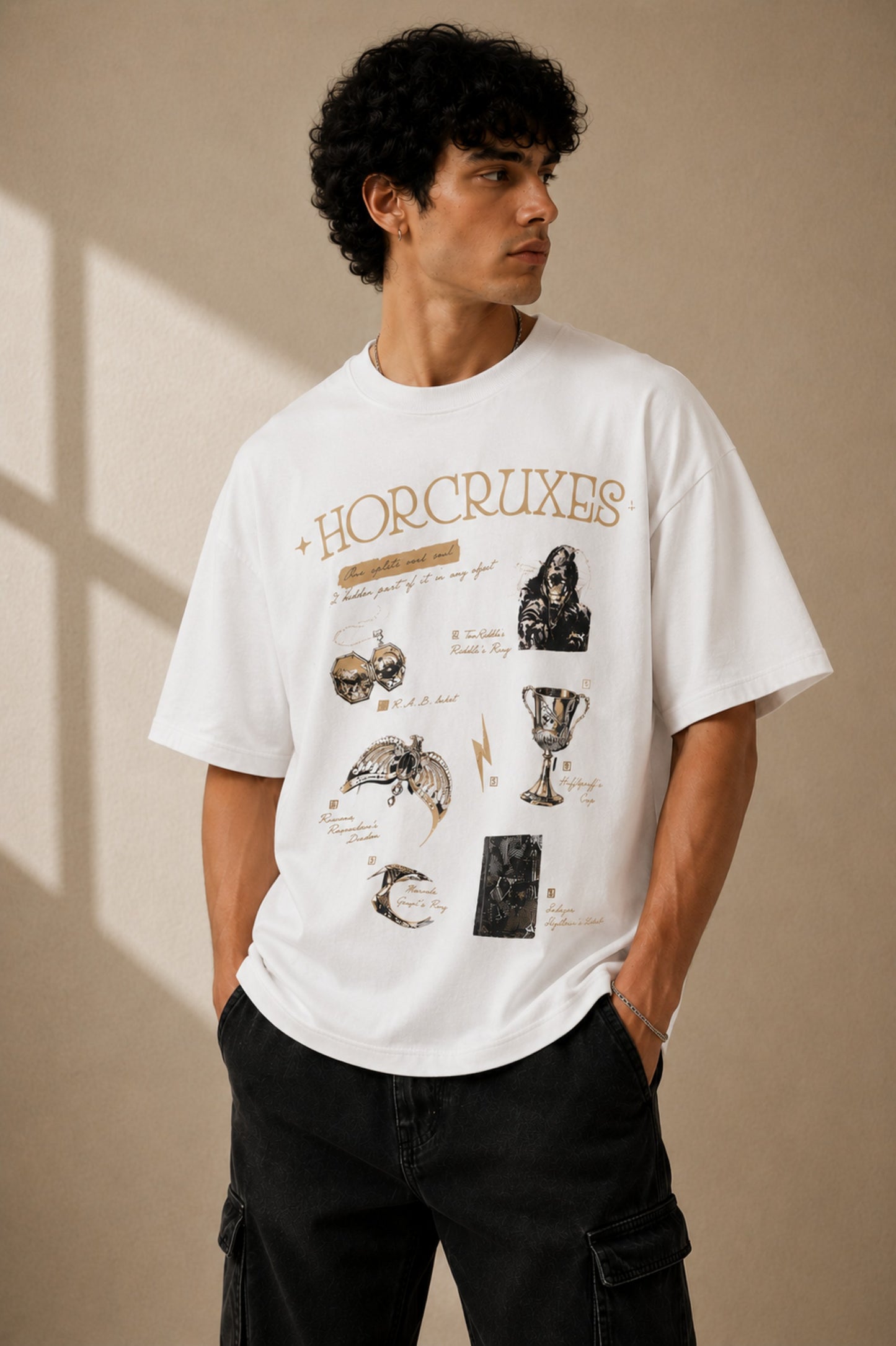 Beige oversized t-shirt with 'HORCRUXES' graphic and iconic Harry Potter items, showcasing premium cotton fabric and relaxed fit. - white