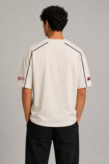 Beige oversized t-shirt with large red and black HOT WHEELS 'Original Since 1968' graphic print on the front, showcasing premium fabric texture.