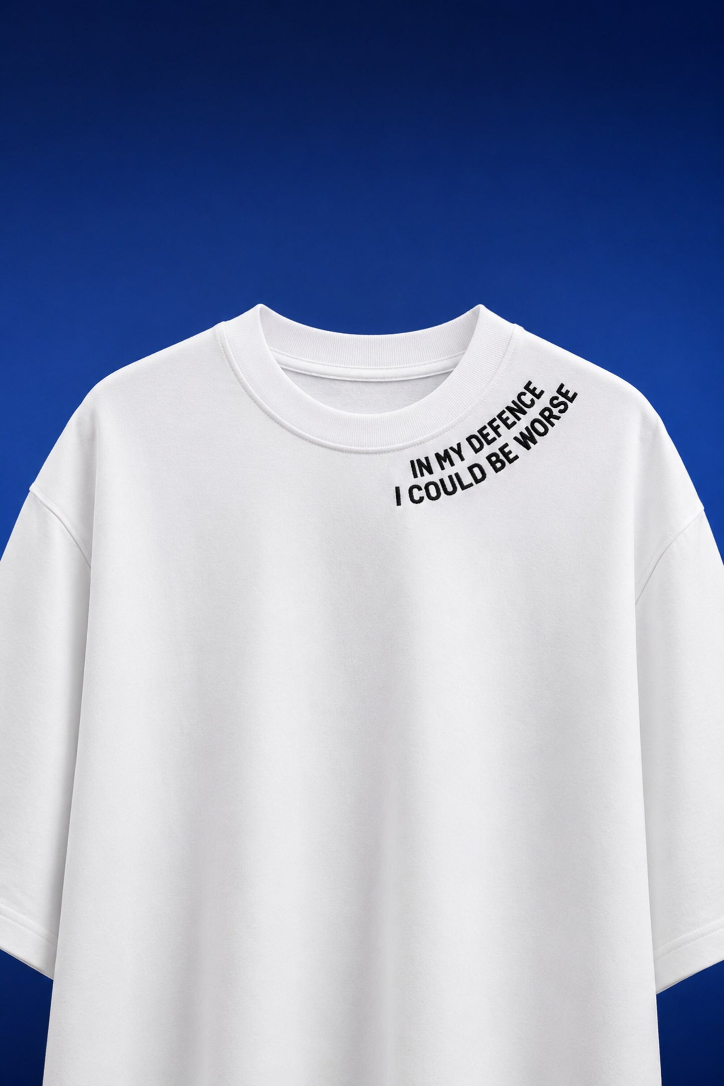 White oversized t-shirt with In My Defence I Could Be Worse diagonal bold text print on chest, quote fashion India - white