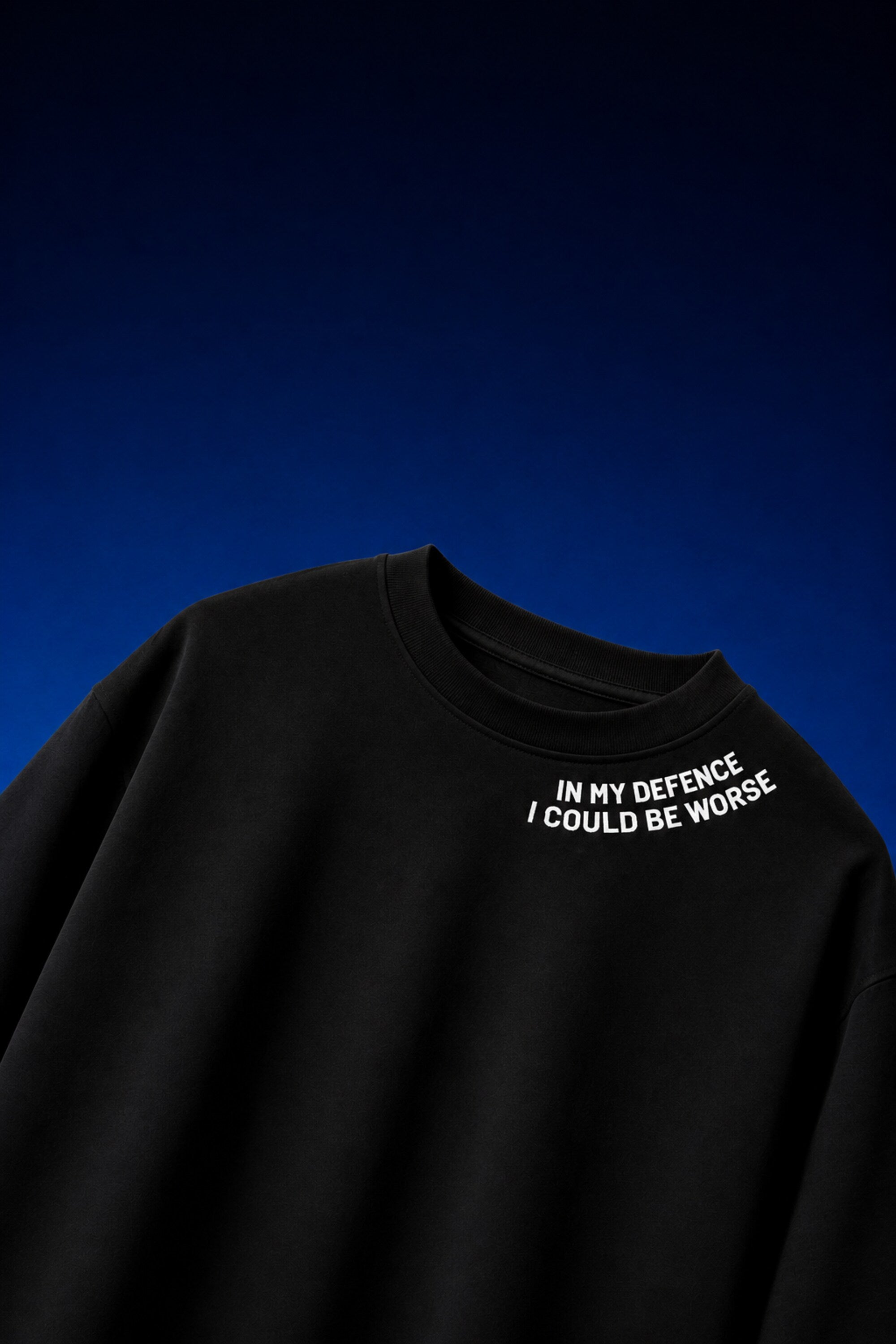 White oversized t-shirt with In My Defence I Could Be Worse diagonal bold text print on chest, quote fashion India