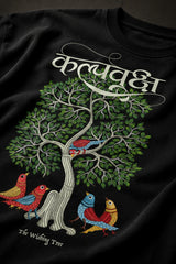 Man wearing a black Kalpvruksh oversized t-shirt with a colorful tree and bird graphic print on the back. Features Hindi script and 'The Wishing Tree' text. Streetwear style. - black