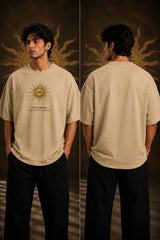 Model wearing a black KARMA oversized t-shirt with a golden sun graphic and the Sanskrit phrase 'कर्मण्येवाधिकारस्ते' (Your right is to action alone). - beige