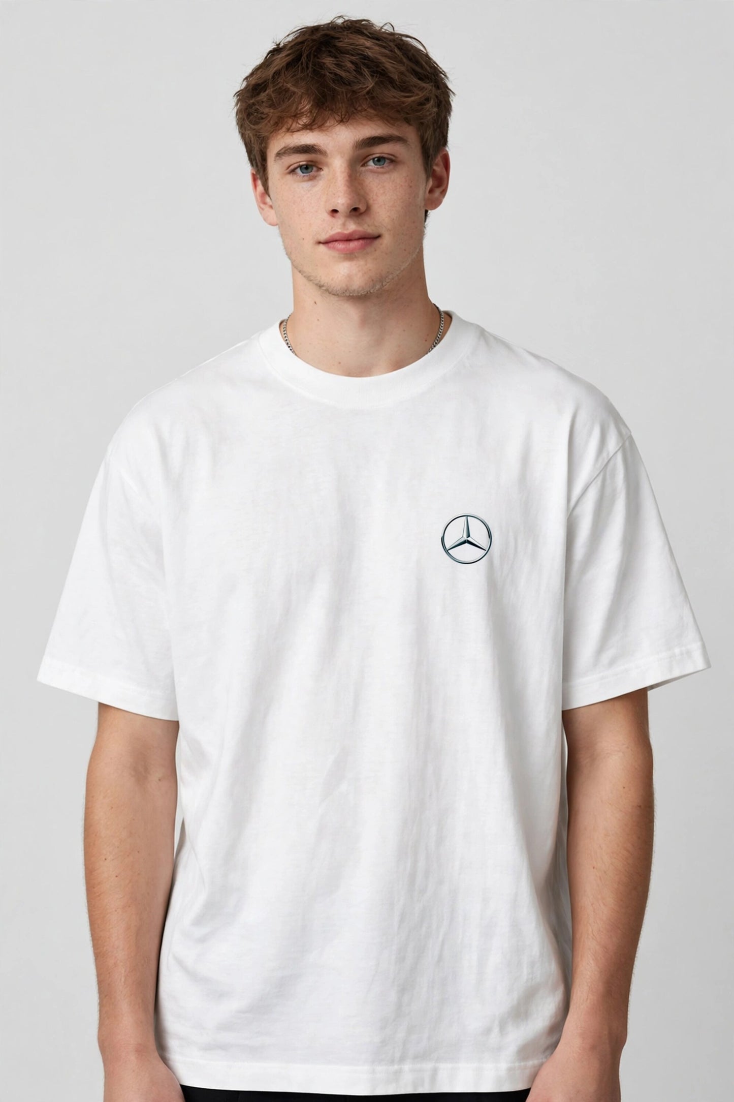 Model wearing white POPCASE Kimi Antonelli Mercedes oversized t shirt with teal MERCEDES Petronas F1 car back graphic and bio text