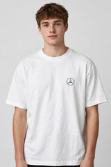 Model wearing white POPCASE Kimi Antonelli Mercedes oversized t shirt with teal MERCEDES Petronas F1 car back graphic and bio text