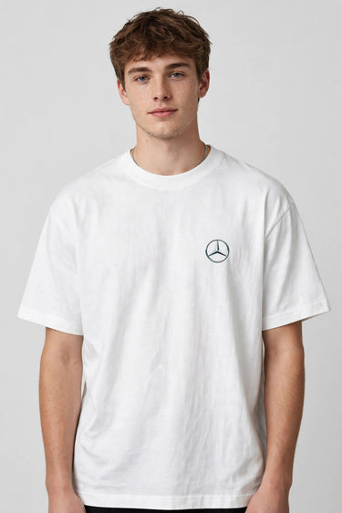 Model wearing white POPCASE Kimi Antonelli Mercedes oversized t shirt with teal MERCEDES Petronas F1 car back graphic and bio text