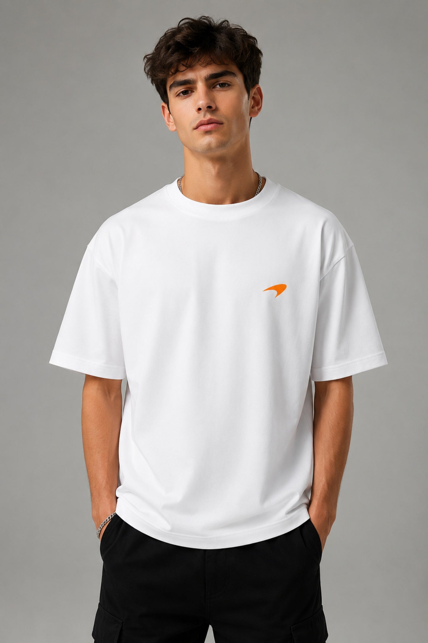 Model wearing white POPCASE Lando Norris McLaren oversized t shirt with orange speed mark logo on left chest