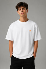 Model wearing white POPCASE Lando Norris McLaren oversized t shirt with orange speed mark logo on left chest