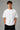 Model wearing white POPCASE Lando Norris McLaren oversized t shirt with orange speed mark logo on left chest