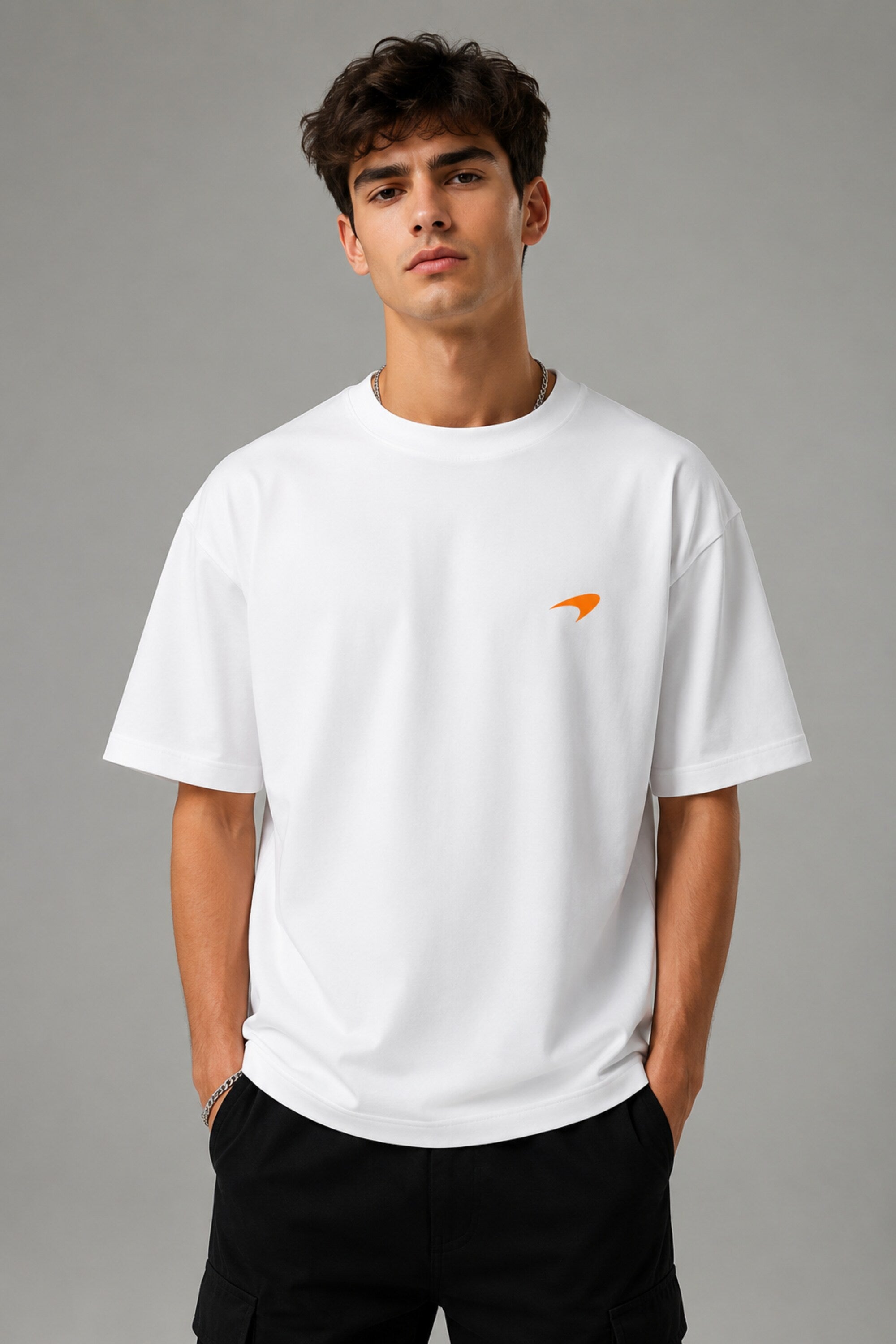 Model wearing white POPCASE Lando Norris McLaren oversized t shirt with orange speed mark logo on left chest