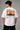 Model wearing white POPCASE Lando Norris McLaren oversized t shirt with orange speed mark logo on left chest